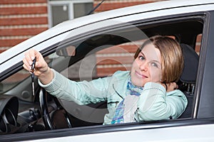 Ignition key in hand of woman in car