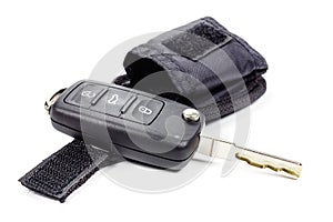 Ignition key with storage pouch on a white background