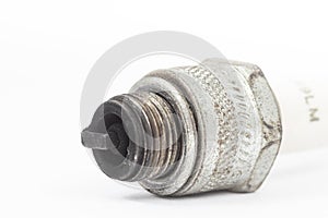 Ignition spark plug with platinum electrode. Automotive parts isolated above white background
