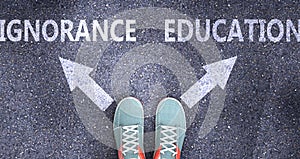 Ignorance and education as different choices in life - pictured as words Ignorance, education on a road to symbolize making