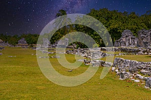 Iguana lizard in ancient ruins of Maya in El Rey Archaeological Zone near Cancun, Yukatan, Mexico with Milky Way Galaxy stars