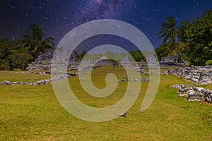 Iguana lizard in ancient ruins of Maya in El Rey Archaeological Zone near Cancun, Yukatan, Mexico with Milky Way Galaxy stars