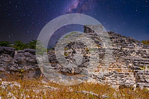 Iguana lizard in ancient ruins of Maya in El Rey Archaeological Zone near Cancun, Yukatan, Mexico with Milky Way Galaxy stars