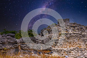 Iguana lizard in ancient ruins of Maya in El Rey Archaeological Zone near Cancun, Yukatan, Mexico with Milky Way Galaxy stars