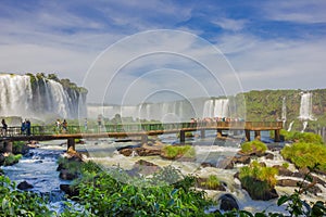 IGUAZU, BRAZIL - MAY 14, 2016: little bridge over the river close to the bottom of the falls, lot of people taking