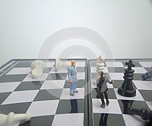 Iillustration for photo War, battle or politic situation concept, 2 standing mini figure, negoitation or debate beyond chess