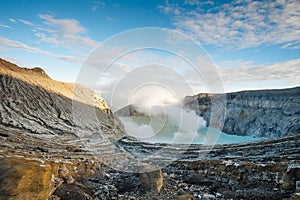 Ijen volcano complex in the morning and turquoise water lake.