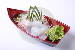 Ika (squid) Sashimi in wooden boat dish isolated on white backgr