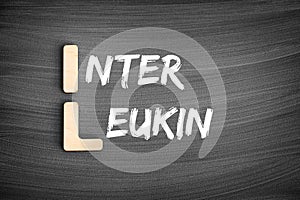 IL - interleukin acronym, medical concept on blackboard