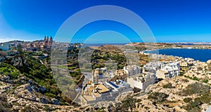 Il-Mellieha, Malta - Beautiful panoramic skyline view of Mellieha town on a bright summer day with Paris Church, Agatha Red Tower