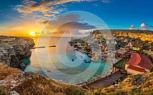 Il-Mellieha, Malta - Panoramic skyline view of the famous Popeye Village at Anchor Bay at sunset