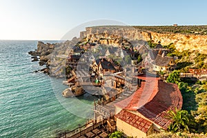 Il-Mellieha, Malta - Panoramic skyline view of the famous Popeye Village at Anchor Bay at sunset