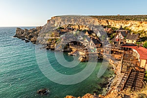 Il-Mellieha, Malta - Panoramic skyline view of the famous Popeye Village at Anchor Bay at sunset