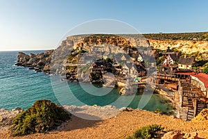 Il-Mellieha, Malta - Panoramic skyline view of the famous Popeye Village at Anchor Bay at sunset