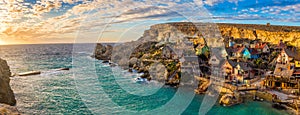 Il-Mellieha, Malta - Panoramic skyline view of the famous Popeye Village at Anchor Bay at sunset