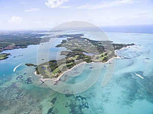 Ile aux Cerfs, Deer Island from above. Landscape with ocean and beach, yacht in background. Mauritius