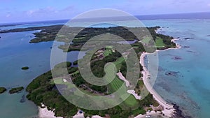 Ile aux Cerfs Privately Owned Island Beach in Mauritius. Golf field and Coastline in background 