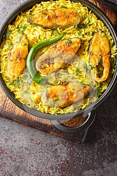 Ilish Pulao Bengali Style Hilsa Fish Pilaf closeup on the plate. Vertical top view