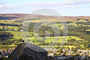 Ilkley Yorkshire England People climbing the cow and calf rocks