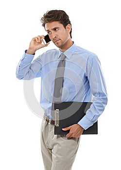 Ill be right there. Studio shot of a young businessman talking a cellphone isolated on white.