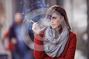 Ill bring the smoke, you bring the fire. Portrait of a beautiful and fashionable young woman smoking a cigarette in an