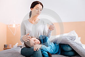 Ill child on the knees of a worried mother