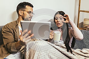 Ill couple having medical teleconsultation using digital tablet at home