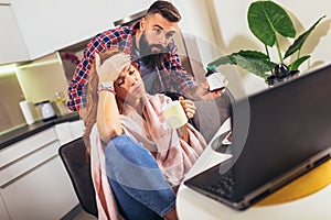 Ill couple having medical teleconsultation using laptop at home photo