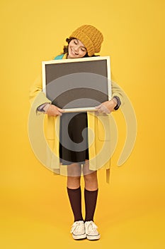 Ill do my own homework. Small child hold empty blackboard for homework on yellow background. School homework assignment