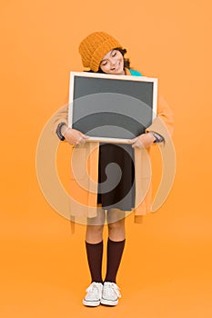 Ill do my own homework. Small child hold empty blackboard for homework on yellow background. School homework assignment