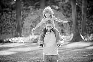 Ill give a piggy-back ride. Happy man carry son sitting on shoulders. Happy kid ride piggy-back