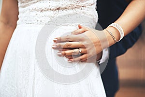 Ill always hold you dear my love. an unrecognizable newlywed couple holding hands on their wedding day.