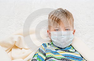 Ill little boy in medicine health-care mask