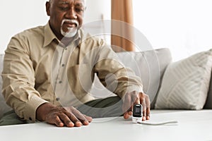 Ill Older Man With Pulse-Oxymeter Measuring Oxygen Saturation At Home photo