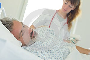 Ill patient lying on bed in hospital