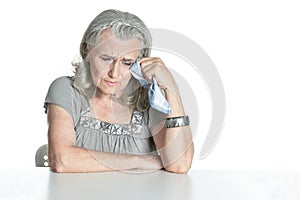Ill senior woman posing isolated on white background