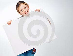 Ill share your message. Studio shot of an adorable little girl holding a blank placard.