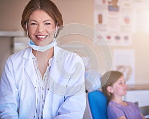 Ill take care of your little ones smile. Portrait of a female dentist standing in her office with her patient in the