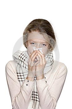 Ill teenage girl with tissue on white background