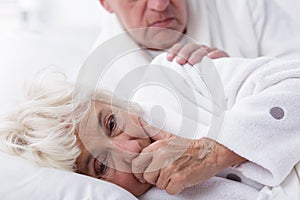 Ill woman coughing in bed
