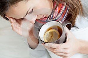 Ill woman drinking tea