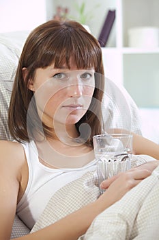 Ill woman with glass water