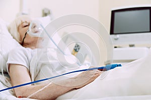 Ill woman with pulse oximeter at hospital