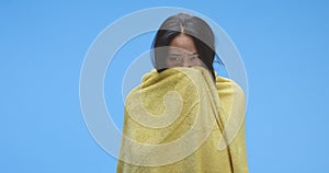 Ill woman wrapped in blanket