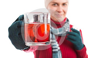 Ill young woman holding a cup of hot tea