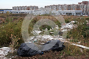 Illegal city dump in the wasteland in the dry grass