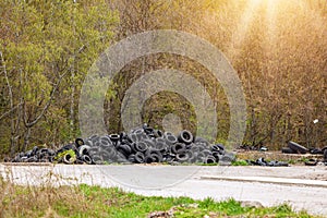 Illegal dump near the country road in the country on sunny day.