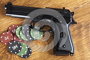 Illegal gambling concept of handgun with betting chips