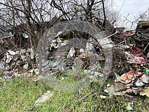 Illegal Landfill in residential area. The problem of environmental pollution in the city center, plastic and other waste