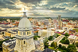 Illinois State Capitol and Springfield skyline at sunset.